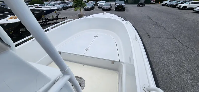 Slide: The Image of 2000 Boston Whaler Justice 24 boat, white deck, parked in a lot. - 10