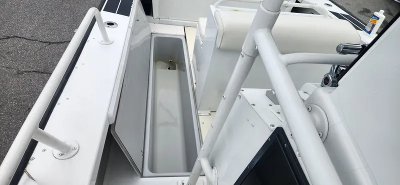 Slide: The Image of 2000 Boston Whaler Justice 24 boat interior with open storage compartment. - 12