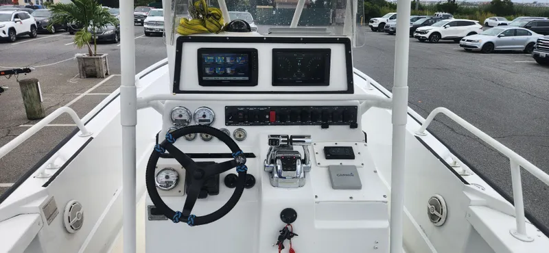 Slide: The Image of Boston Whaler Justice 24 boat dashboard with steering wheel and controls, 2000 model. - 5