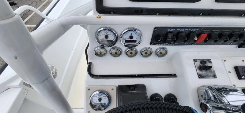 Slide: The Image of Control panel of a 2000 Boston Whaler Justice 24 boat with gauges and switches. - 7