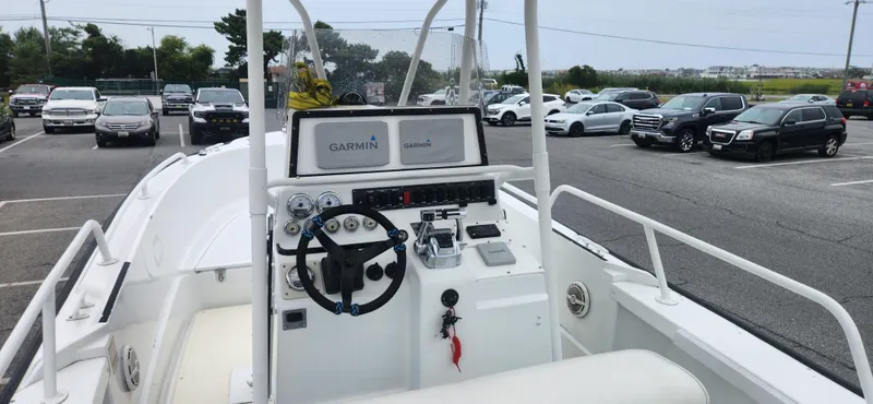 Slide: The Image of Boston Whaler Justice 24 boat cockpit with Garmin electronics, parked in a lot, 2000 model. - 9