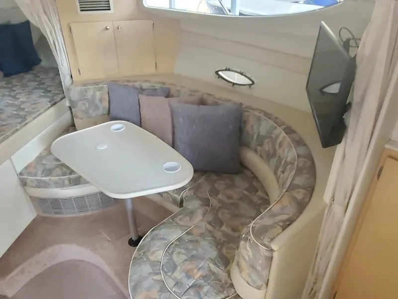 Slide: The Image of Interior of 2000 Bayliner 3055 Ciera Sunbridge DX/LX with cozy seating and table. - 10