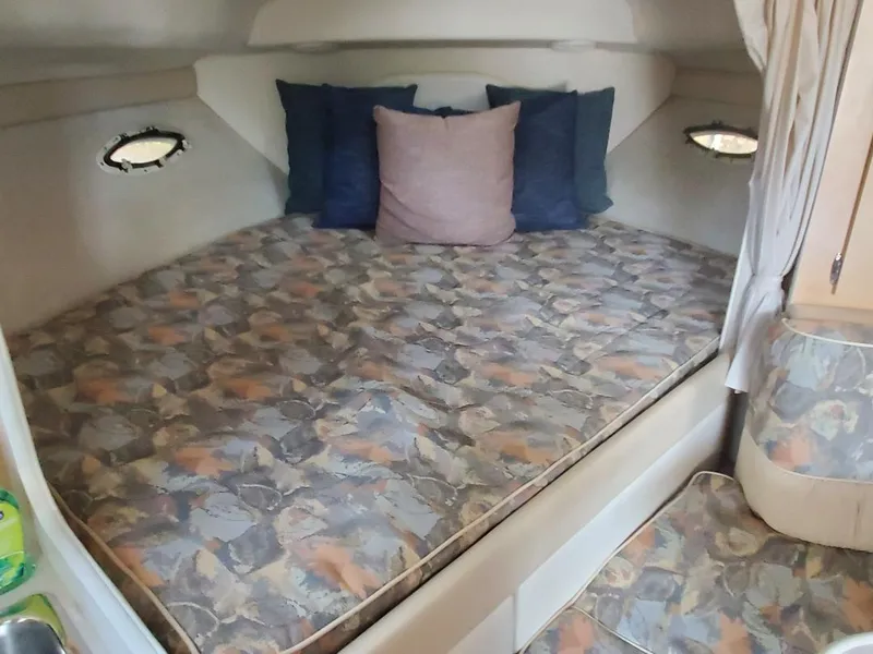 Slide: The Image of 2000 Bayliner 3055 Ciera Sunbridge DX/LX cabin with patterned bedding and cushions. - 12