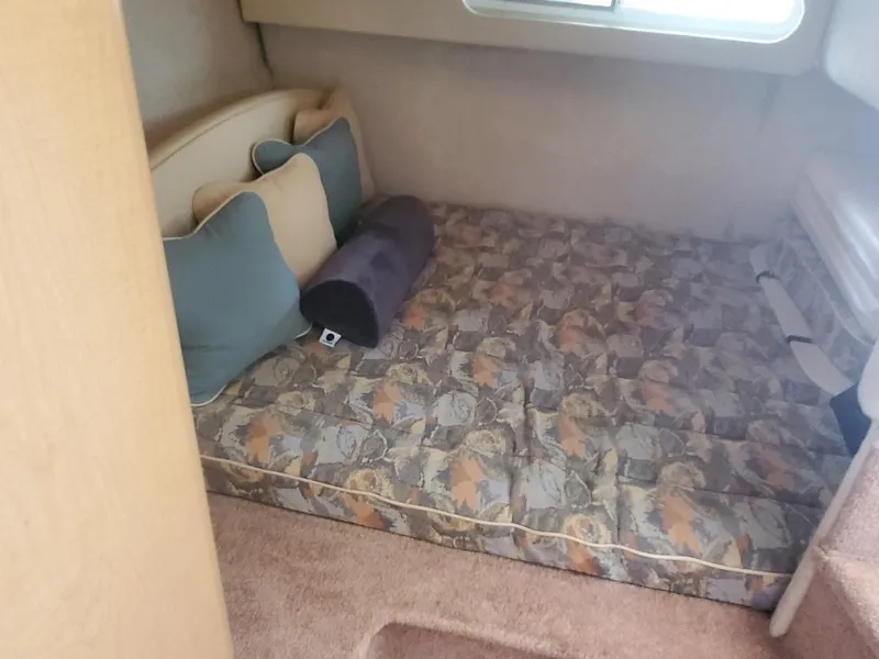 Slide: The Image of Interior cabin of 2000 Bayliner 3055 Ciera Sunbridge with patterned bedding and cushions. - 14