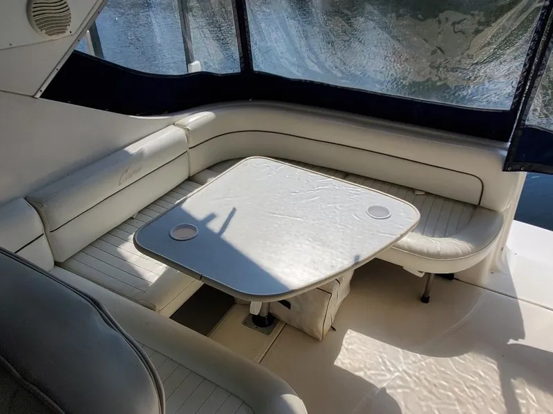 Slide: The Image of 2000 Bayliner 3055 Ciera Sunbridge DX/LX interior with white seating and table. - 15