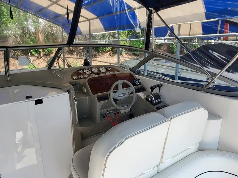 Slide: The Image of 2000 Bayliner 3055 Ciera Sunbridge DX/LX cockpit with steering wheel and control panel. - 3