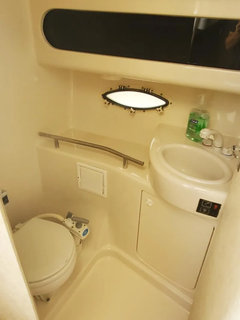 Slide: The Image of 2000 Bayliner 3055 Ciera Sunbridge DX/LX boat bathroom with toilet and sink. - 9