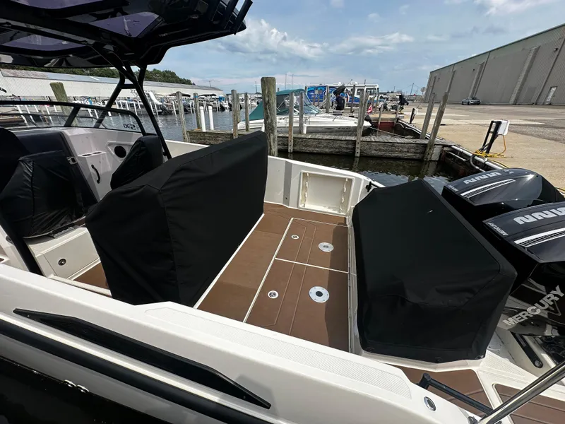 Slide: The Image of 2024 Navan S30 boat interior with covered seating and dock view. - 12