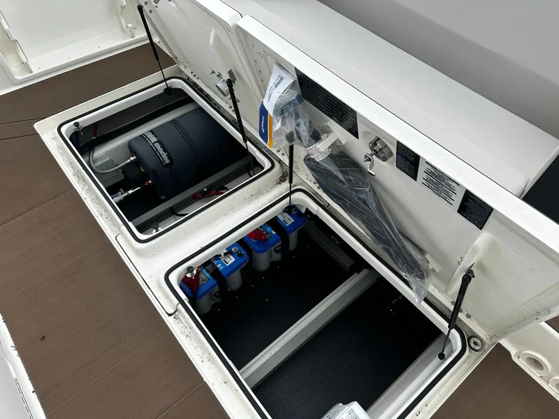 Slide: The Image of Open storage compartments on a 2024 Navan S30 boat, revealing equipment and batteries. - 18