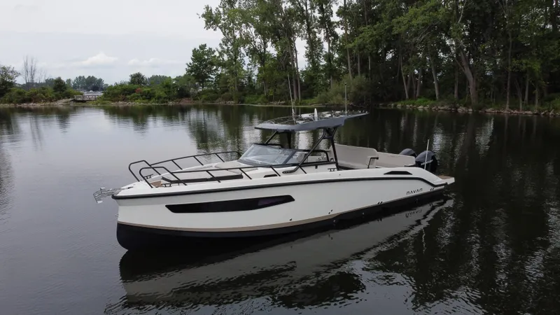 Slide: The Image of 2024 Navan S30 boat on a calm lake surrounded by trees. - 2