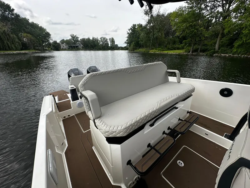 Slide: The Image of 2024 Navan S30 boat interior with cushioned seating on a serene lake. - 20