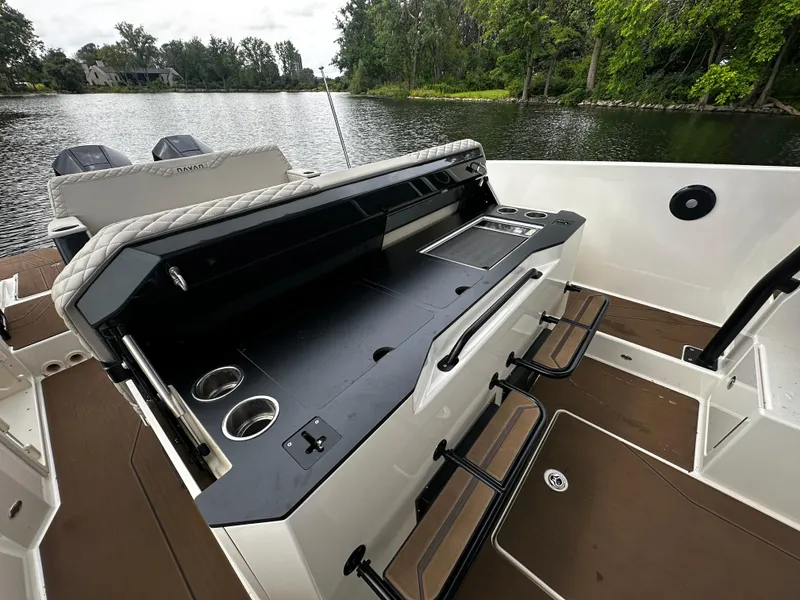Slide: The Image of 2024 Navan S30 boat interior with sleek design and modern amenities on a serene lake. - 22