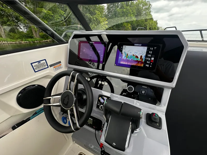 Slide: The Image of 2024 Navan S30 boat dashboard with dual navigation screens and modern steering wheel. - 28
