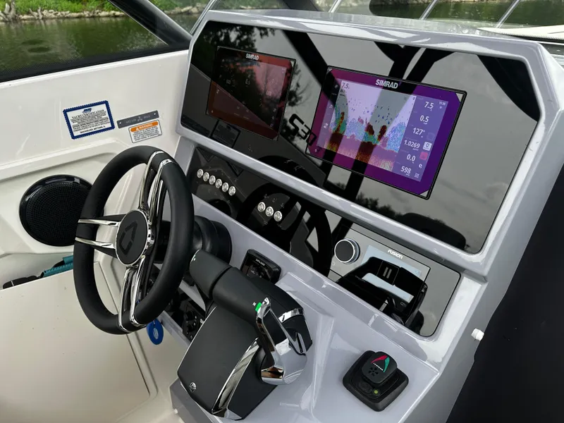 Slide: The Image of 2024 Navan S30 boat dashboard with steering wheel and digital displays. - 29