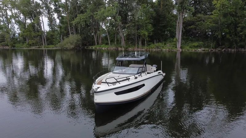 Slide: The Image of 2024 Navan S30 boat on a calm lake surrounded by trees. - 3