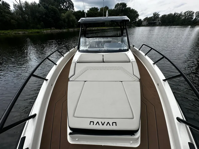 Slide: The Image of 2024 Navan S30 boat on a calm lake, featuring sleek design and comfortable seating. - 37