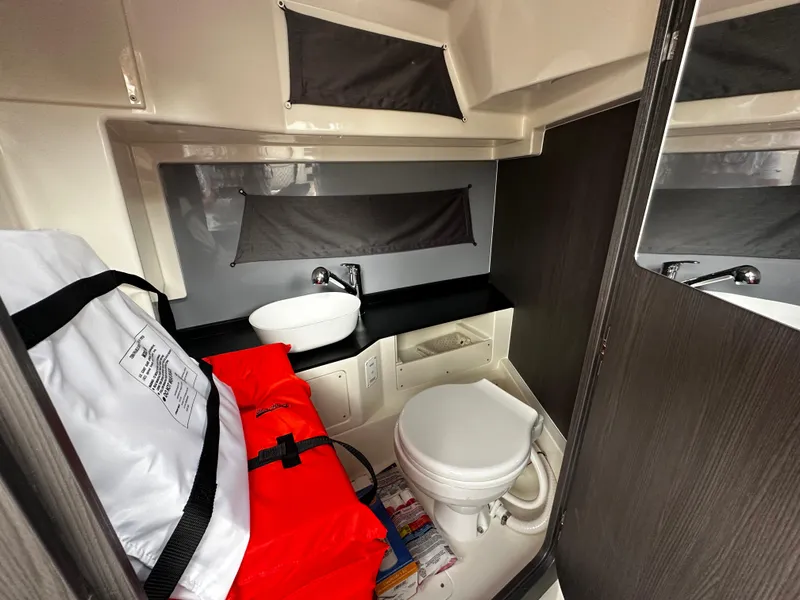 Slide: The Image of 2024 Navan S30 boat bathroom with sink, toilet, and storage compartments. - 45