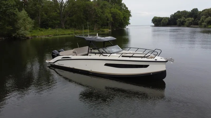 Slide: The Image of 2024 Navan S30 boat on a calm river with lush green surroundings. - 5