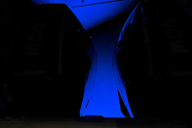 Slide: The Image of 2025 Navan S30 boat illuminated by blue lighting, showcasing sleek design and powerful engines. - 51