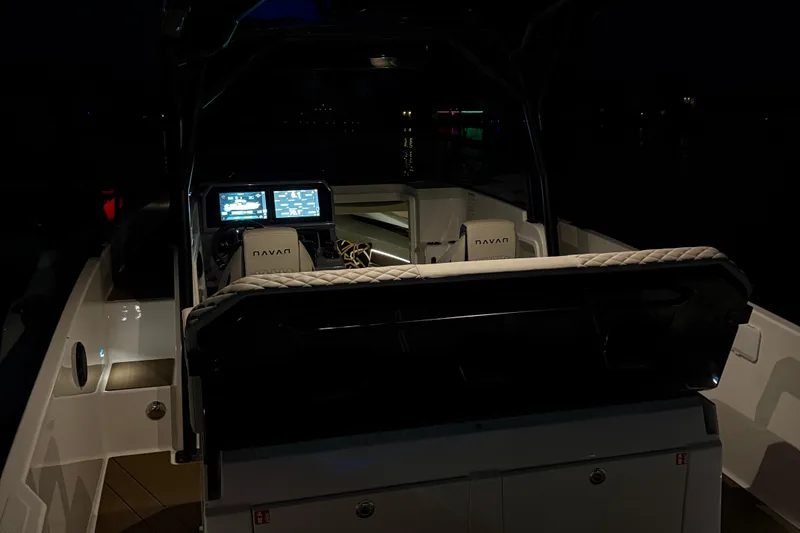 Slide: The Image of 2025 Navan S30 boat interior with illuminated control panels at night. - 52