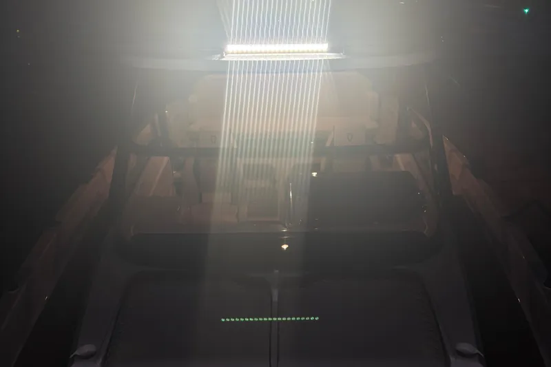 Slide: The Image of 2025 Navan S30 boat illuminated by bright overhead light in dim setting. - 55
