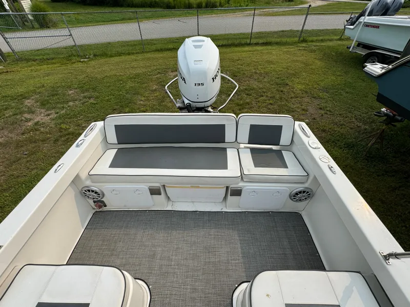 Slide: The Image of 2019 Eastern 21 Pilot boat interior with seating and outboard motor. - 12