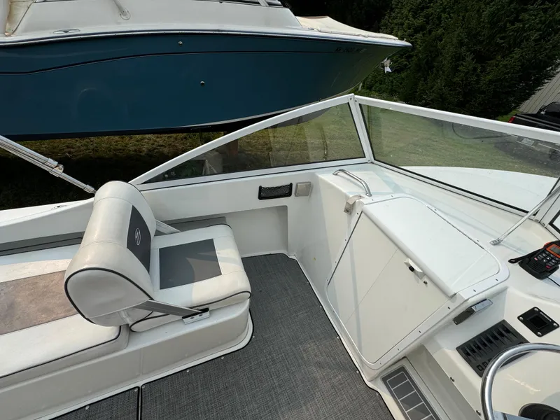 Slide: The Image of Interior of a 2019 Eastern 21 Pilot boat, featuring seating and control panel. - 15