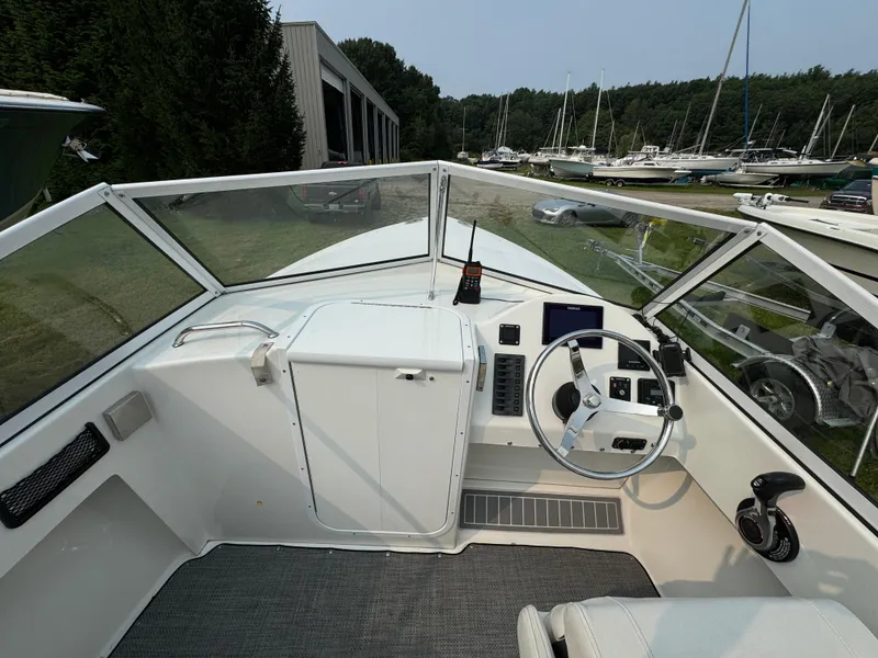 Slide: The Image of Cockpit of 2019 Eastern 21 Pilot boat with steering wheel and controls, docked near marina. - 18