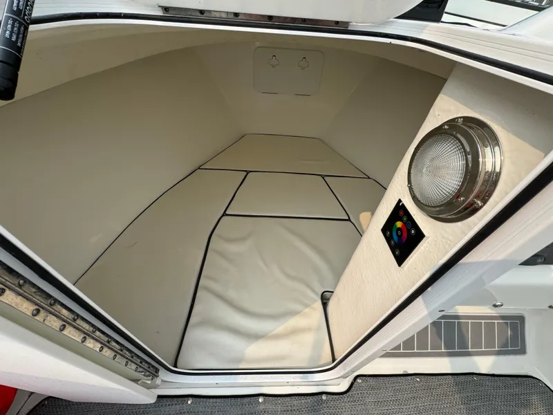 Slide: The Image of Interior cabin of a 2019 Eastern 21 Pilot boat, featuring a light and control panel. - 19