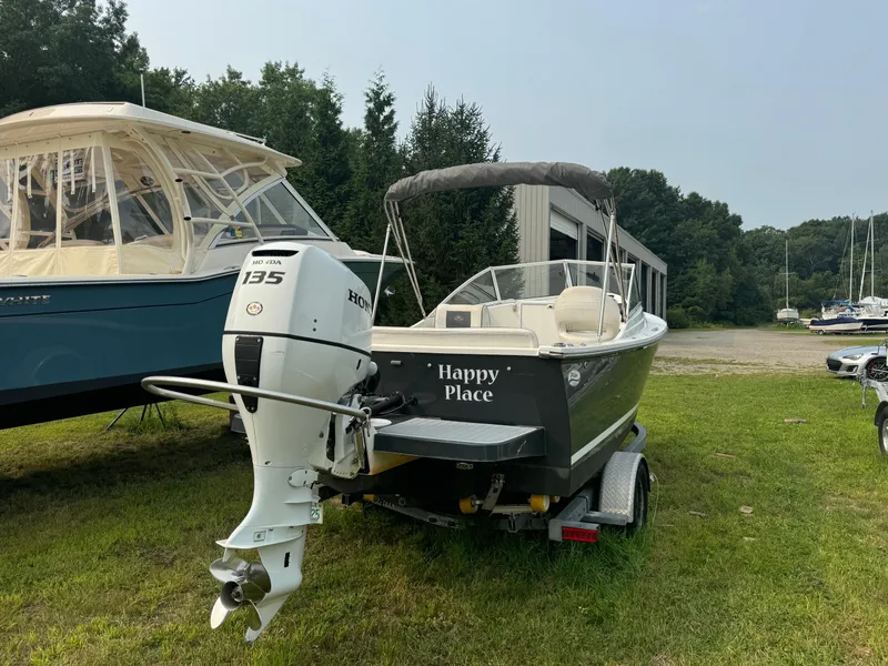 Slide: The Image of 2019 Eastern 21 Pilot boat named "Happy Place" with Honda 135 engine on trailer. - 2