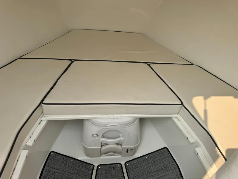 Slide: The Image of Interior cabin of 2019 Eastern 21 Pilot boat with cushioned seating and portable toilet. - 20