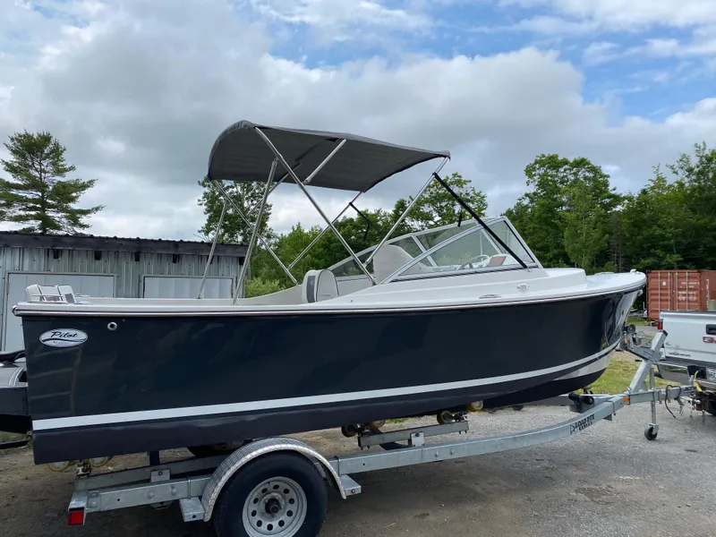 Slide: The Image of 2019 Eastern 21 Pilot boat on trailer, with canopy, parked outdoors. - 26