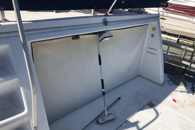 Slide: The Image of 1994 Gibson 50 Cabin Yacht deck with cleaning tools and storage compartment. - 11
