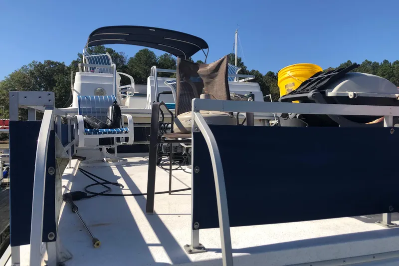 Slide: The Image of 1994 Gibson 50 Cabin Yacht deck with chairs and equipment under clear blue sky. - 12