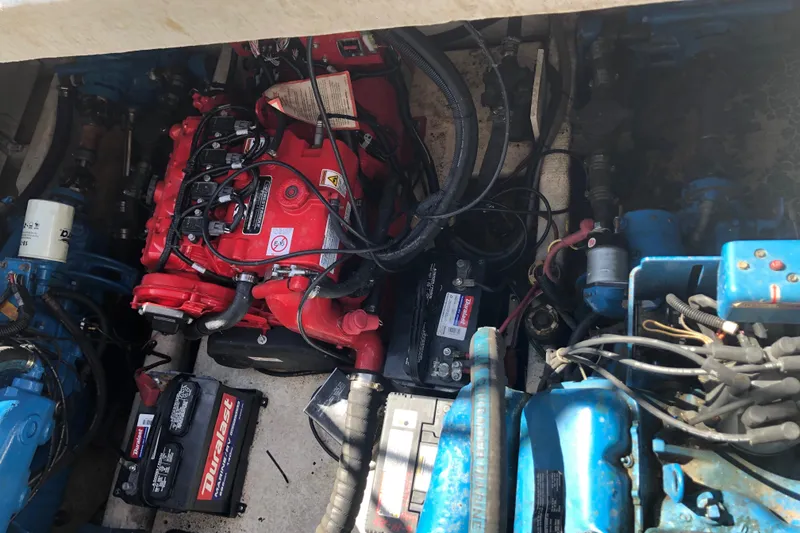 Slide: The Image of Engine compartment of a 1994 Gibson 50 Cabin Yacht with visible batteries and wiring. - 21