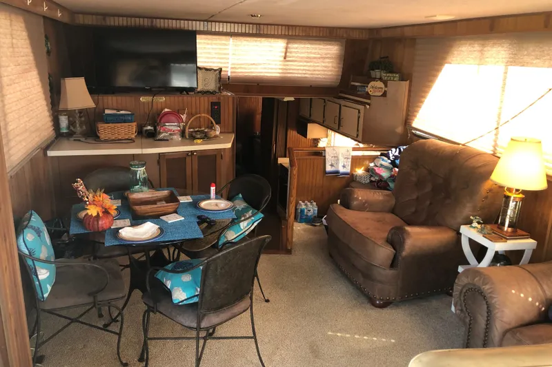 Slide: The Image of Interior of 1994 Gibson 50 Cabin Yacht with cozy seating and dining area. - 24