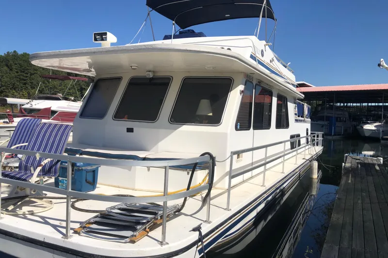 Slide: The Image of 1994 Gibson 50 Cabin Yacht docked, featuring spacious deck and modern design. - 3