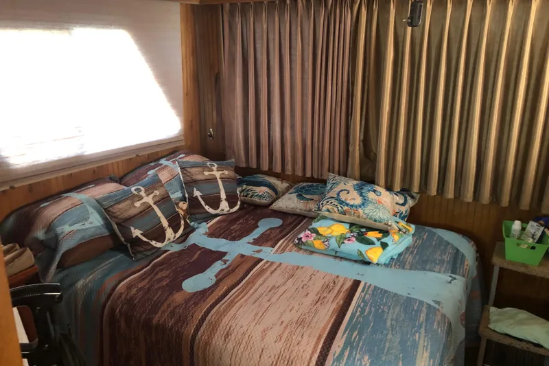 Slide: The Image of Cozy bedroom in 1994 Gibson 50 Cabin Yacht with nautical-themed bedding and decor. - 32