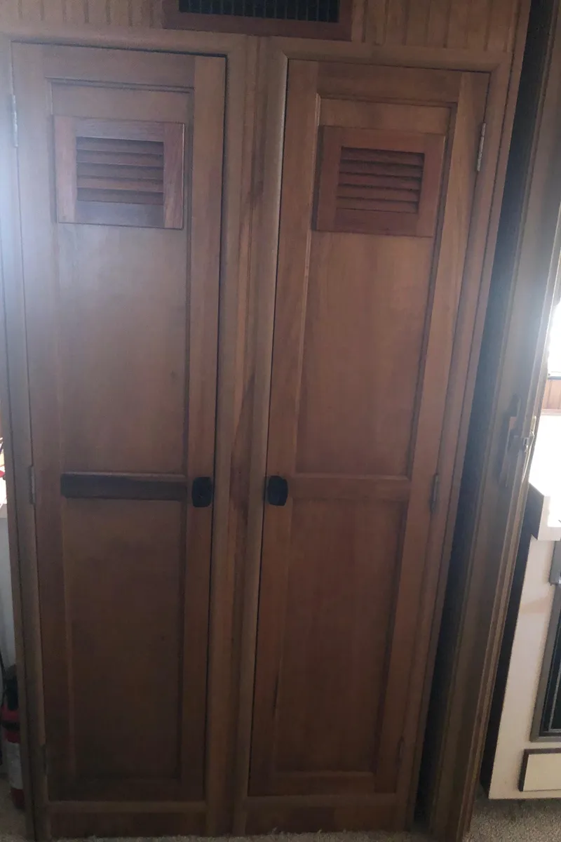 Slide: The Image of Wooden cabinet doors inside a 1994 Gibson 50 Cabin Yacht. - 34
