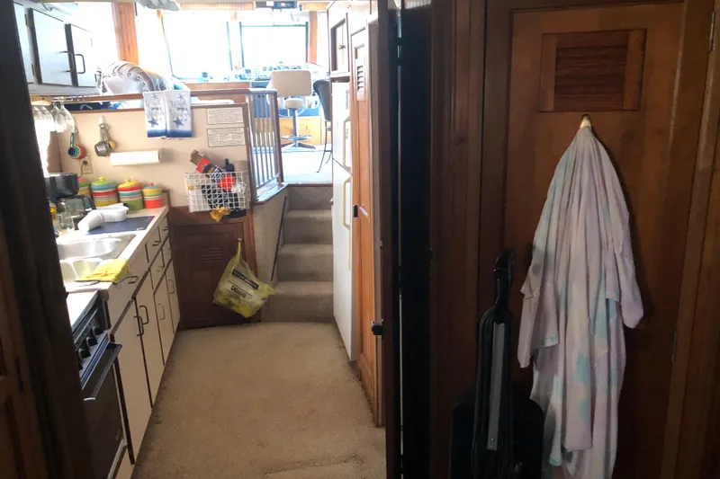 Slide: The Image of Interior of a 1994 Gibson 50 Cabin Yacht featuring a compact kitchen and cozy living space. - 35