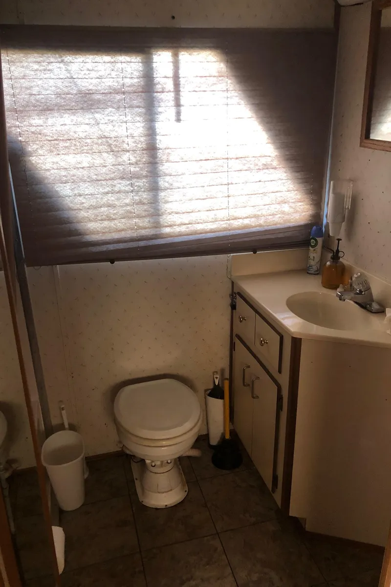 Slide: The Image of Bathroom interior of a 1994 Gibson 50 Cabin Yacht with sink and toilet. - 36