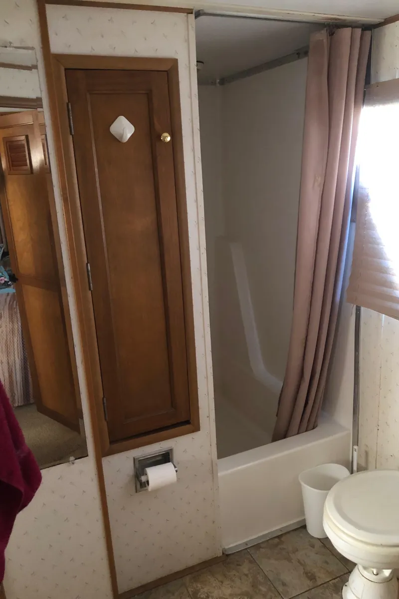 Slide: The Image of Bathroom in 1994 Gibson 50 Cabin Yacht with shower, toilet, and wooden cabinet. - 37