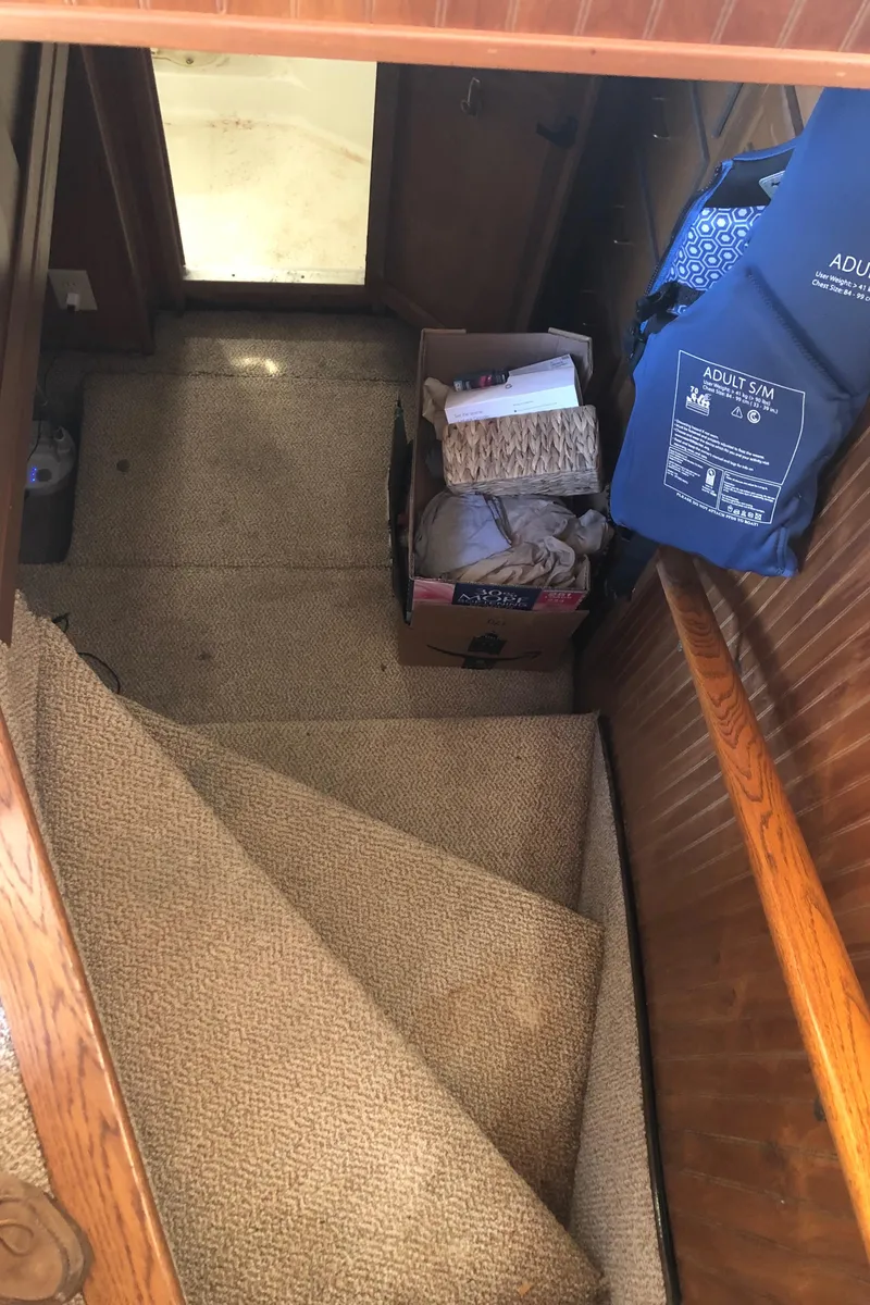 Slide: The Image of Staircase inside 1994 Gibson 50 Cabin Yacht with carpet and storage items. - 39