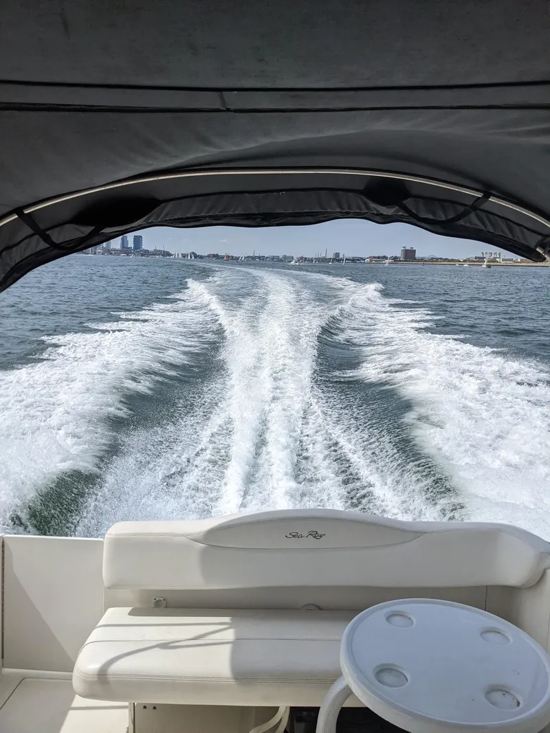 Slide: The Image of 2005 Sea Ray 280 Sundancer cruising on open water, leaving a wake behind. - 13
