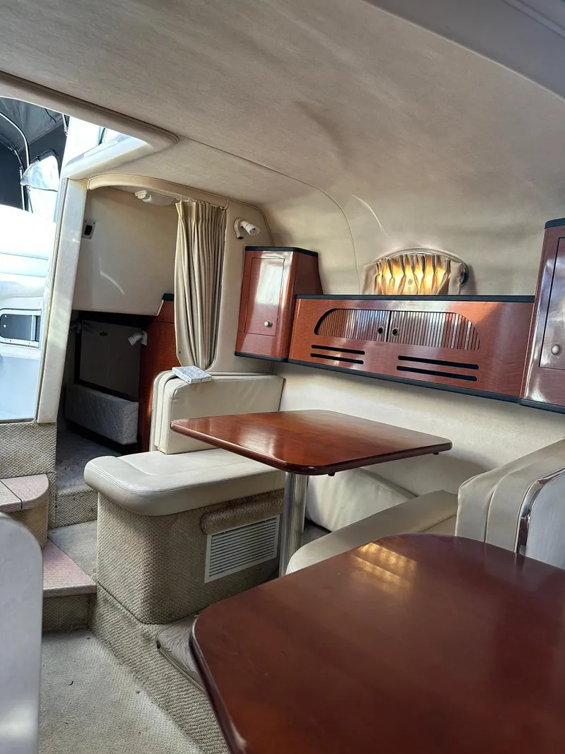 Slide: The Image of Interior of 2005 Sea Ray 280 Sundancer with wood accents and seating area. - 9