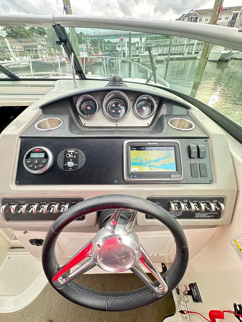 Slide: The Image of 2015 Sea Ray 260 Sundancer dashboard with steering wheel and navigation system. - 12