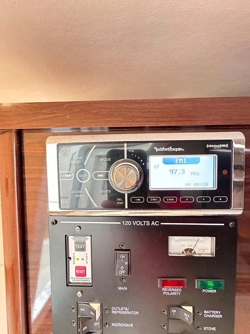 Slide: The Image of Control panel of 2015 Sea Ray 260 Sundancer with radio and electrical switches. - 20