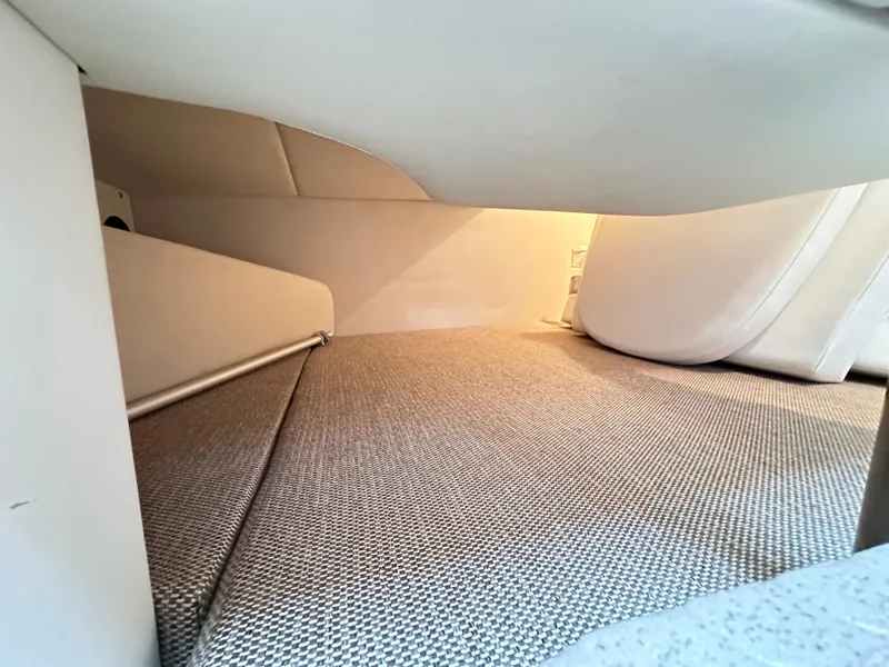 Slide: The Image of Interior cabin space of 2015 Sea Ray 260 Sundancer boat, featuring cozy sleeping area. - 22