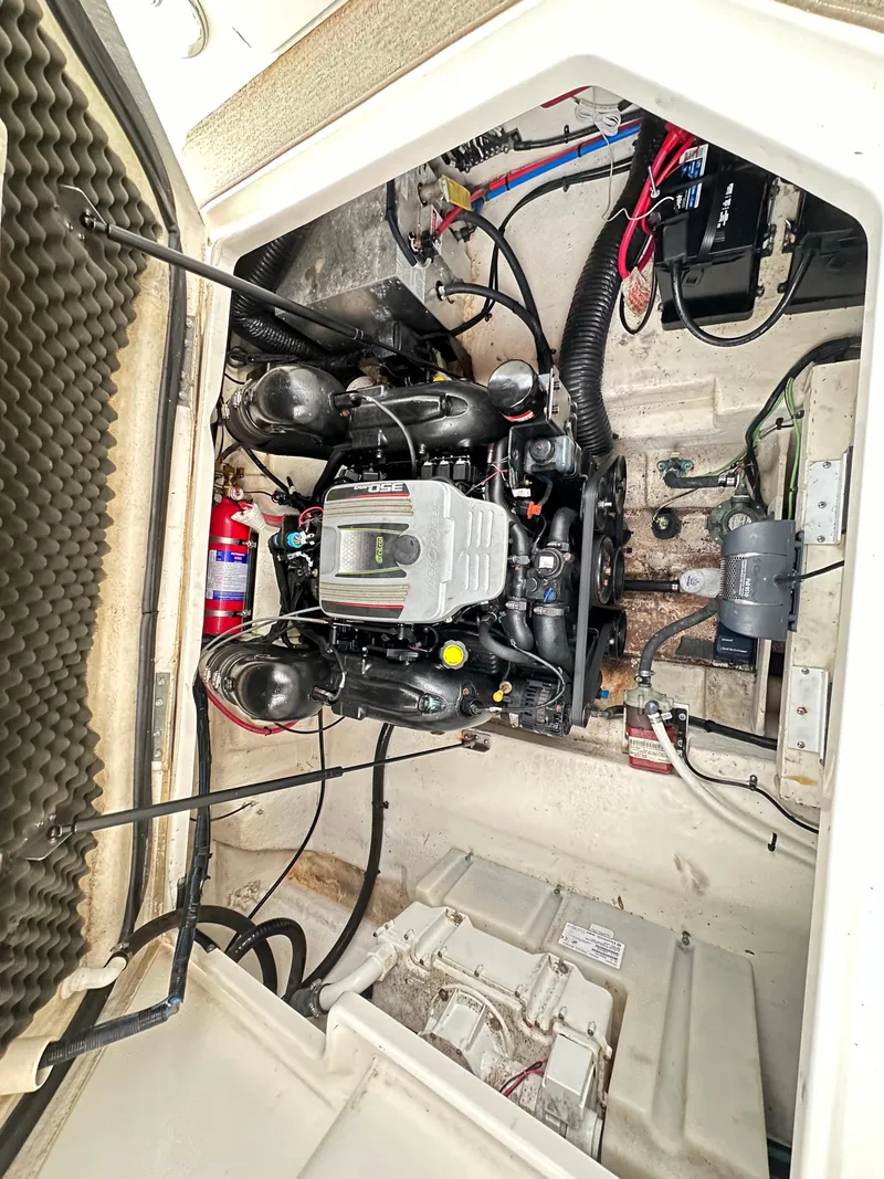 Slide: The Image of 2015 Sea Ray 260 Sundancer engine compartment with visible components and wiring. - 27