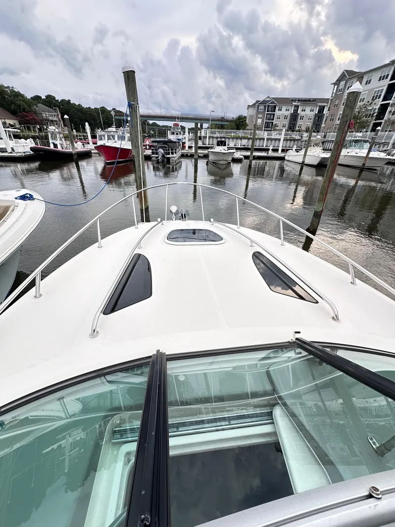 Slide: The Image of 2015 Sea Ray 260 Sundancer docked at a marina with cloudy skies. - 30